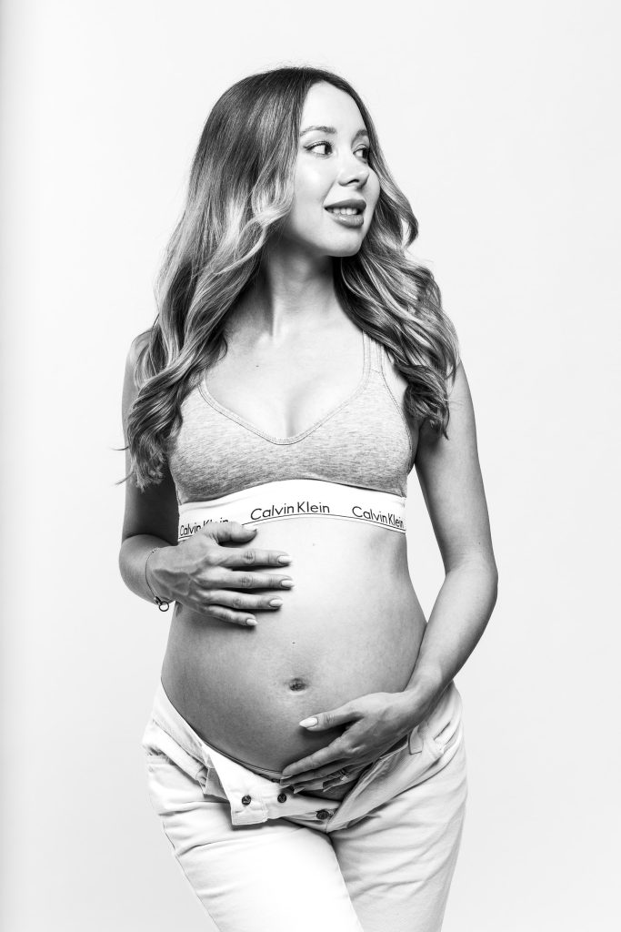 Black and white studio maternity portrait of an expectant mother