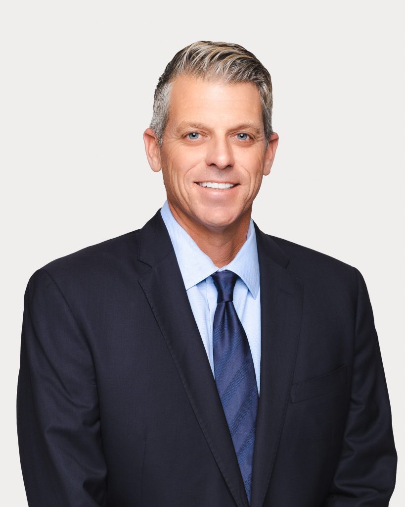 Classic corporate headshot of a man in a suit and tie