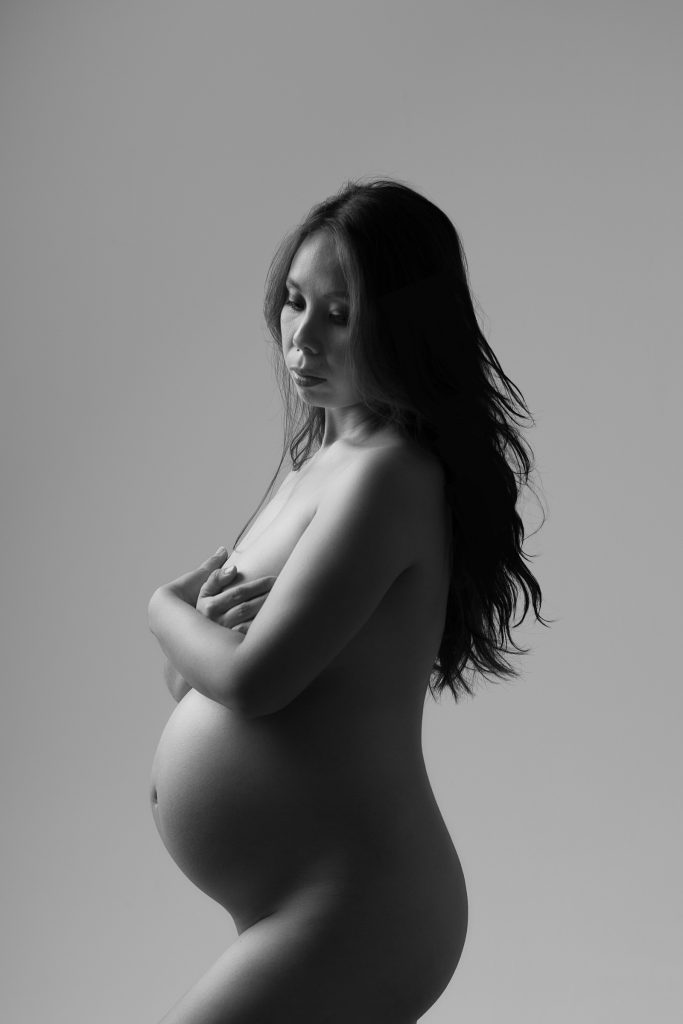 Fine art black and white maternity portrait photographed in the studio