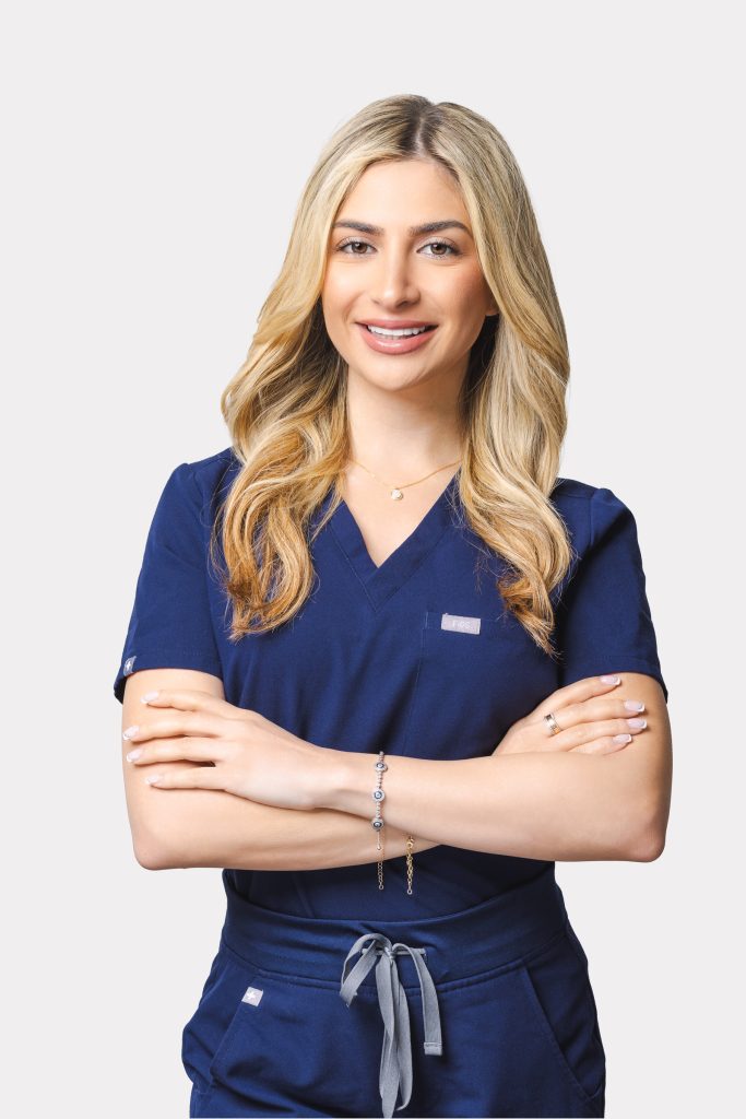 Professional headshot of a woman in medical scrubs