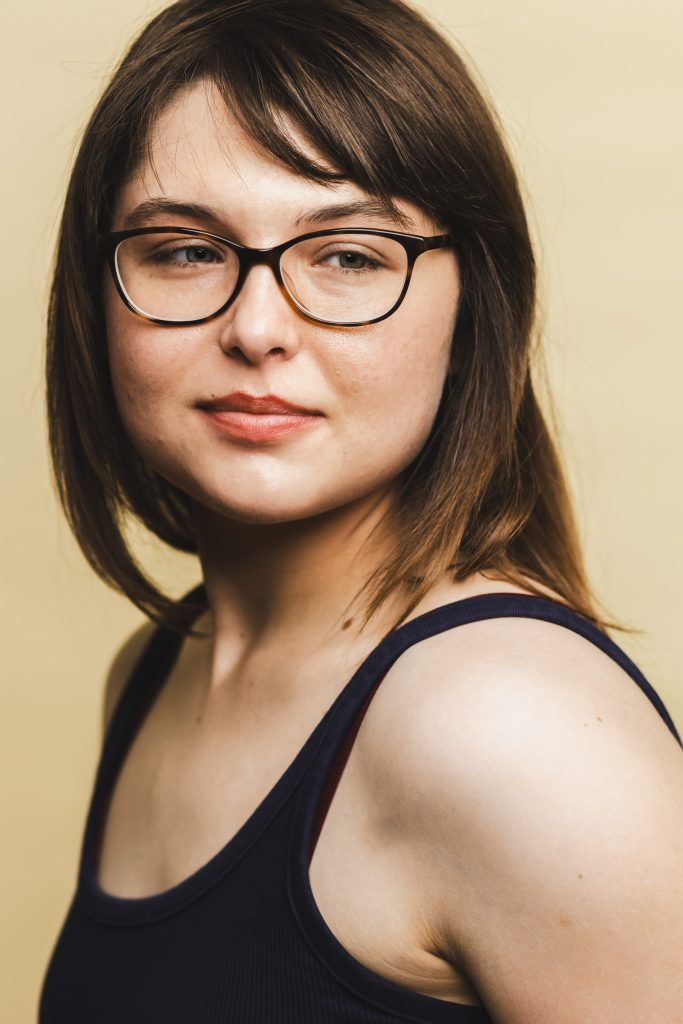 Young actor wearing glasses photographed for a natural actor headshot