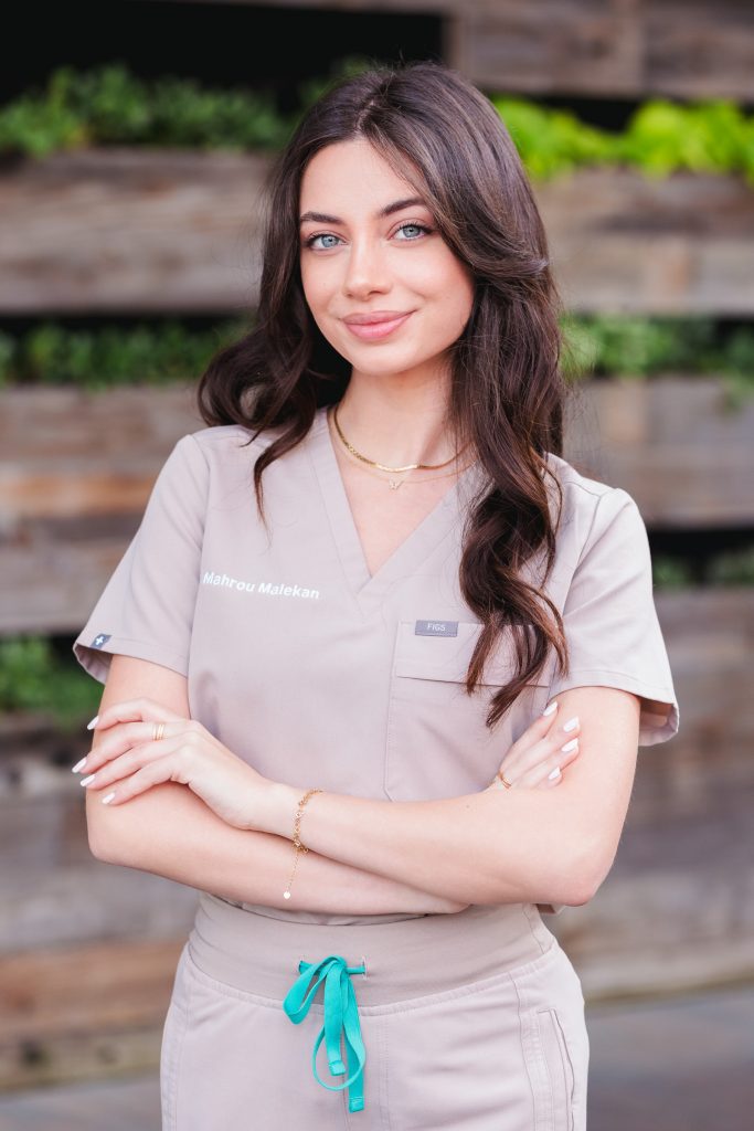 Professional business headshot of a woman in medical scrubs