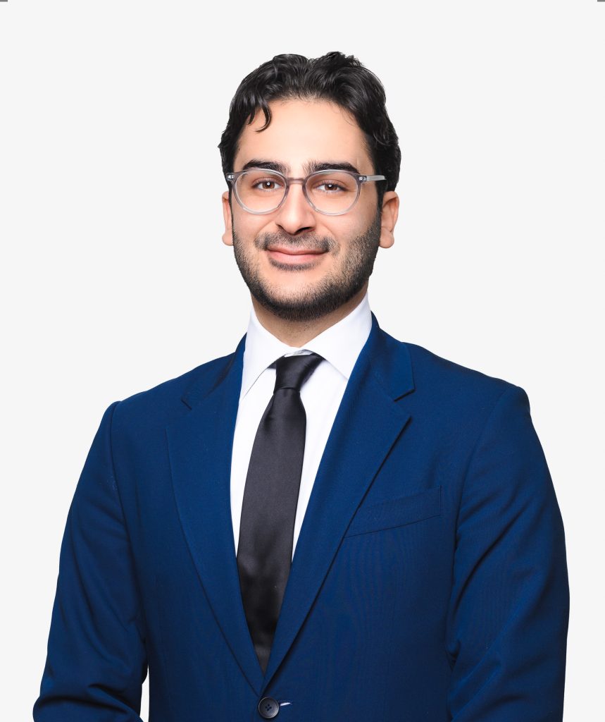 Professional headshot of a man in a blue suit and tie