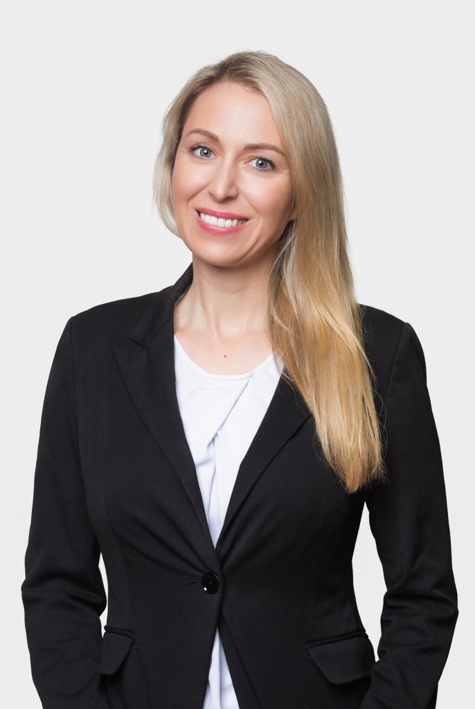 Professional headshot of a woman wearing a black business jacket