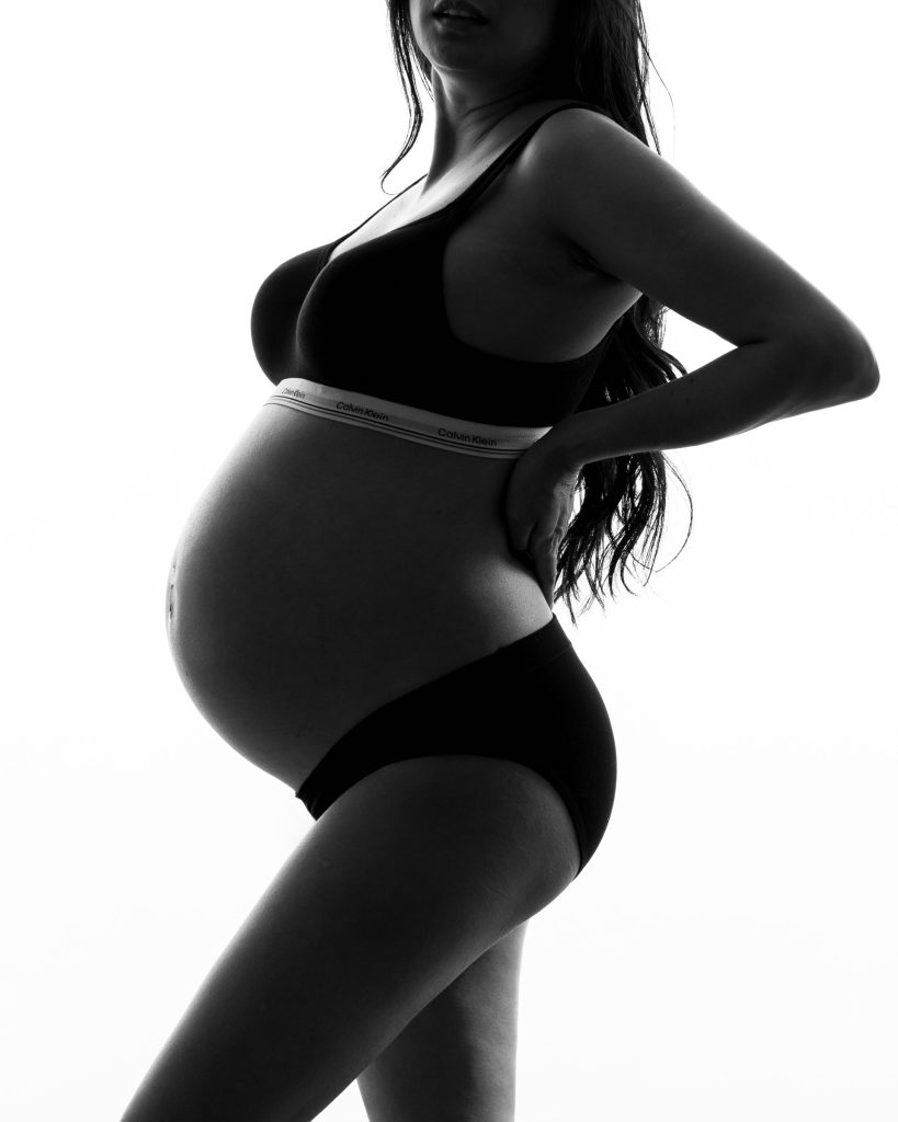 Elegant studio maternity portrait of an expectant mother